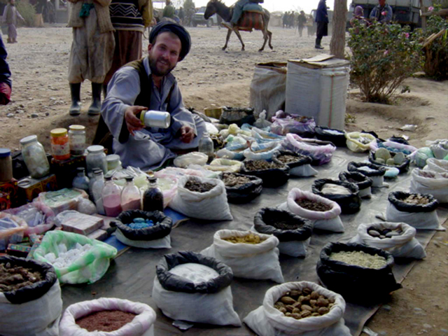 Sidewalk Salesman with Spices and Stones